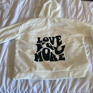 white “love you more” hoodie